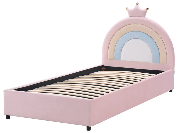 Pink children's bed with rainbow design and crown on a white background