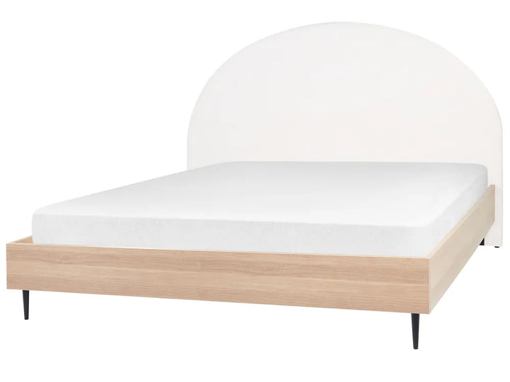 Bed with white mattress and wooden frame on a white background