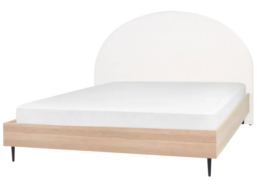 Bed with white mattress and wooden frame on a white background