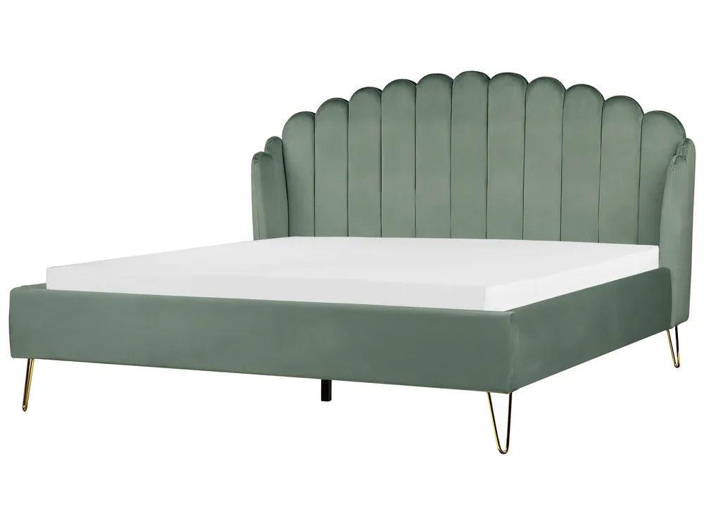 Green bed with scalloped headboard on a white background