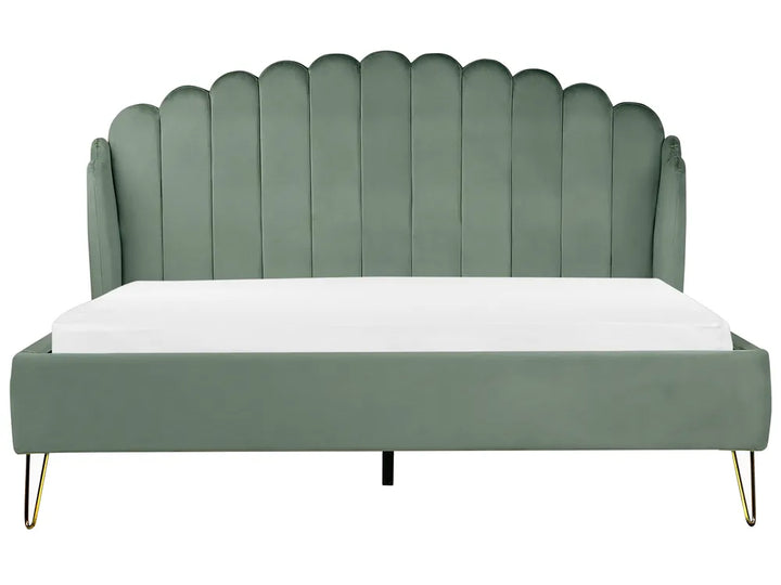 Green upholstered bed with scalloped headboard 