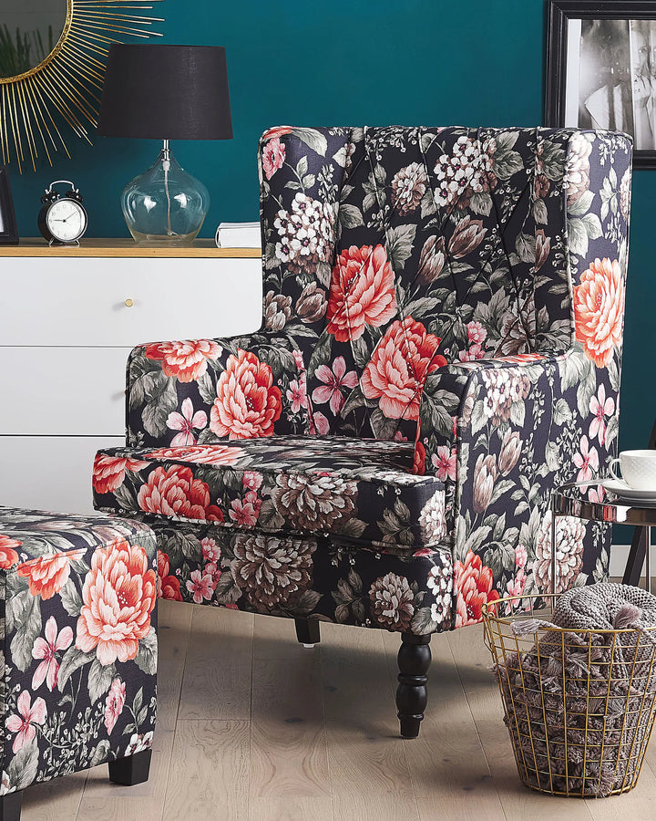 Floral-patterned armchair in a living room setting with a teal wall.