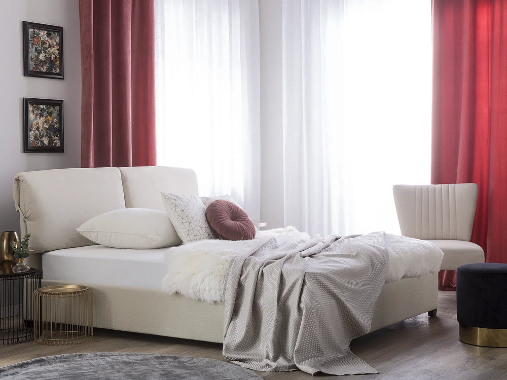 Modern living room with a white sofa, red curtains, and decorative pillows.