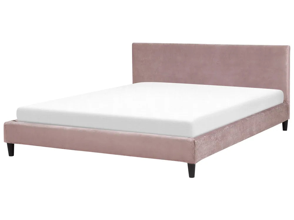 Pink upholstered bed with white mattress on a white background
