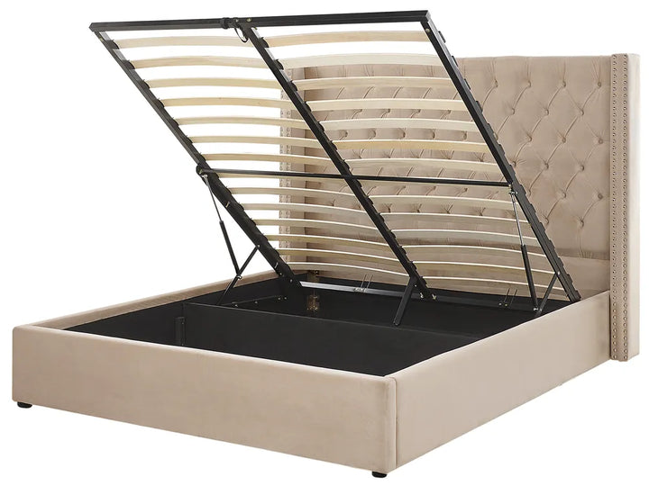 Beige upholstered bed with a black metal frame on a white background