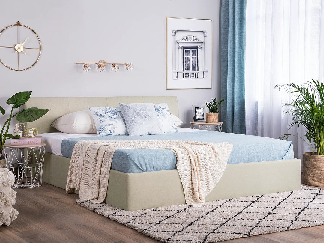 Neatly made bed with decorative pillows and a blanket in a well-lit bedroom.