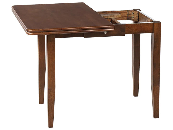 Wooden dining table with a single extension leaf on a white background