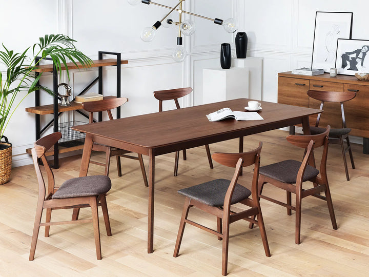 Wooden dining table with chairs in a modern room setting.