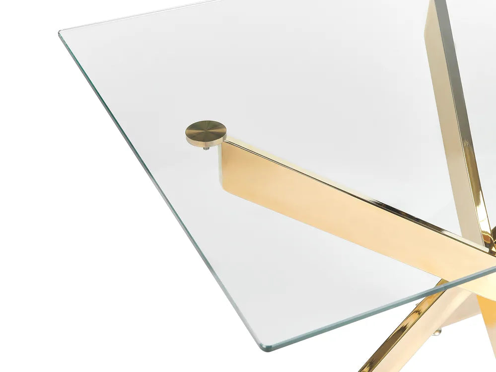 Glass table with gold metal legs on a white background