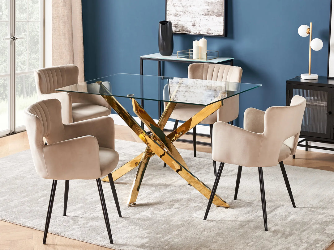 Dining room with a glass table and beige chairs against a blue wall.