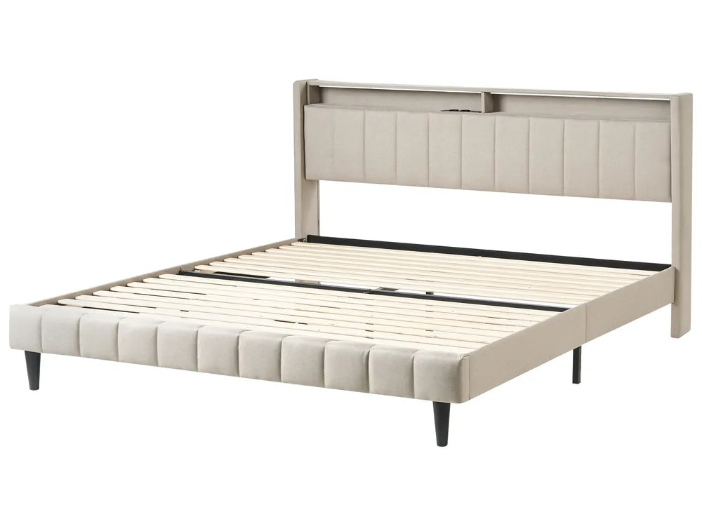 Beige upholstered bed frame on a white background