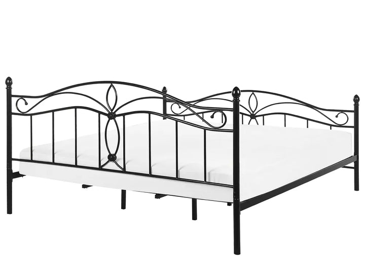 Black metal bed frame with decorative elements on a white background