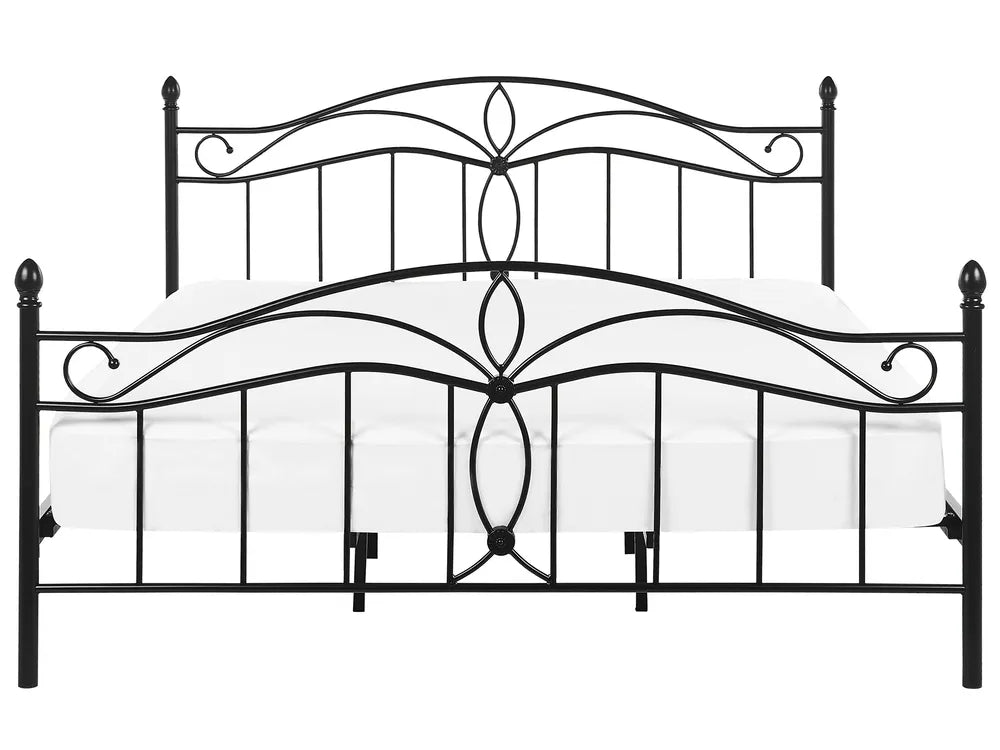 Decorative metal bed frame with intricate designs on a white background