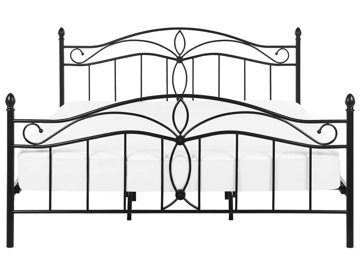 Decorative metal bed frame with intricate designs on a white background