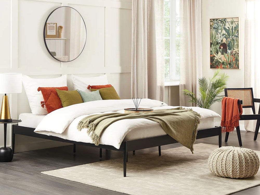 Bedroom with a bed, pillows, and decor elements.