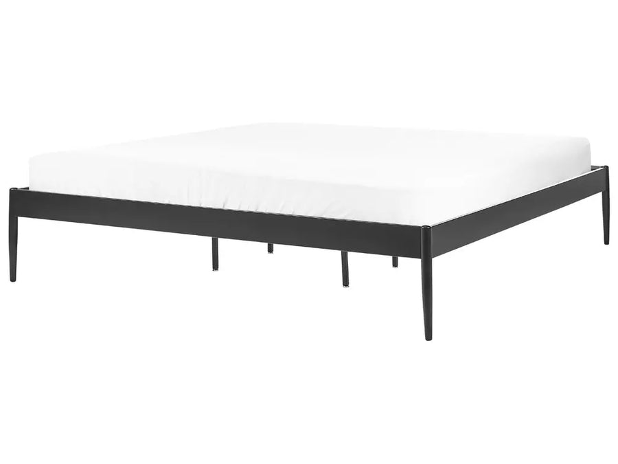 Black metal bed frame with white mattress on a white background