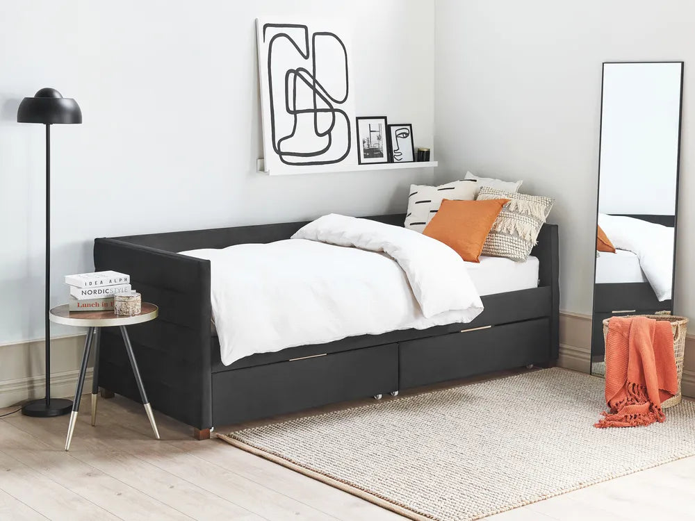 Modern bedroom with a black bed, white bedding, and decorative items.