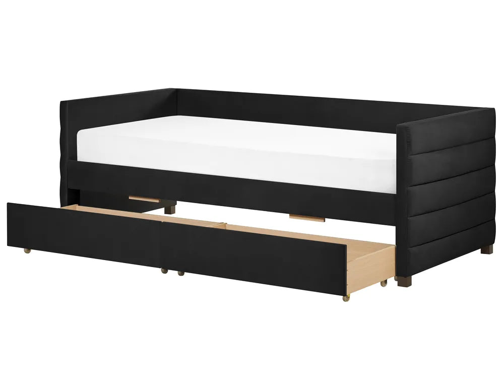 Black bed frame with a white mattress and wooden drawer on a white background