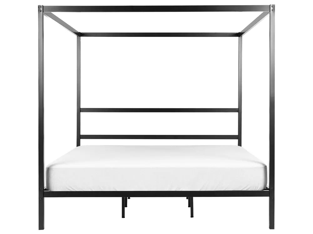 Black metal canopy bed frame with a white mattress on a white background