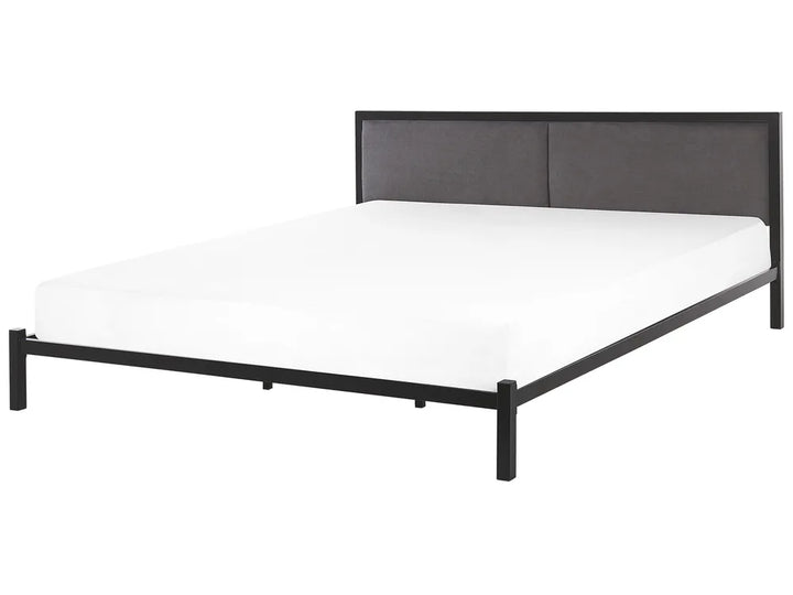 Black metal bed frame with white mattress on a white background