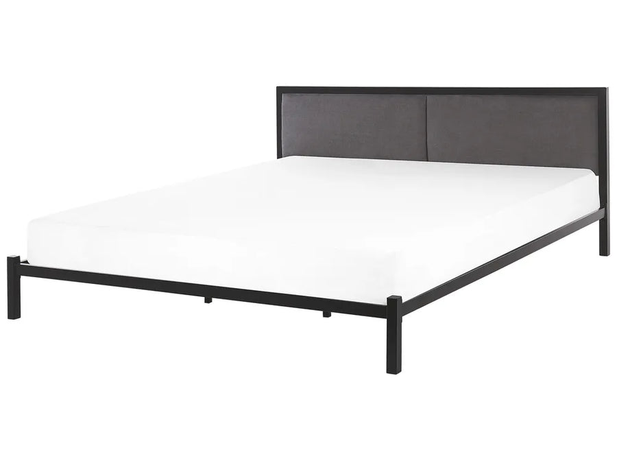 Black metal bed frame with white mattress on a white background