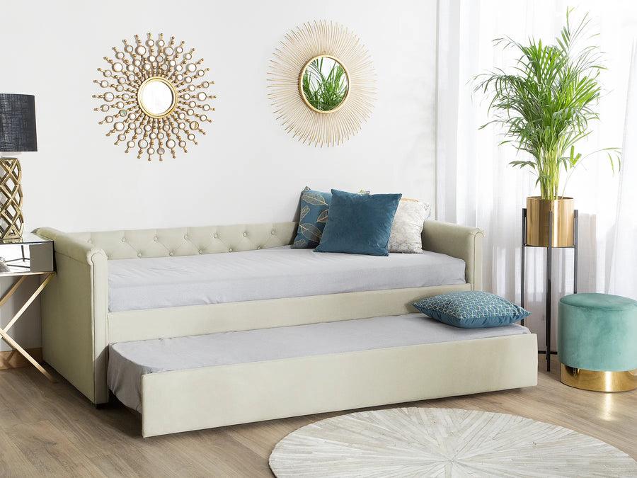 Beige sofa bed in a stylish living room with decorative elements.