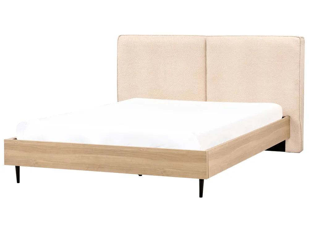 Bed with beige upholstered headboard and wooden frame on a white background
