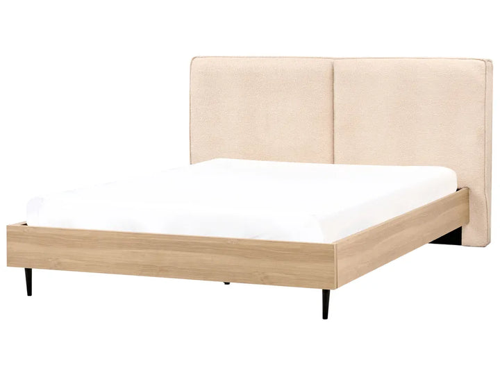 Bed with beige upholstered headboard and wooden frame on a white background