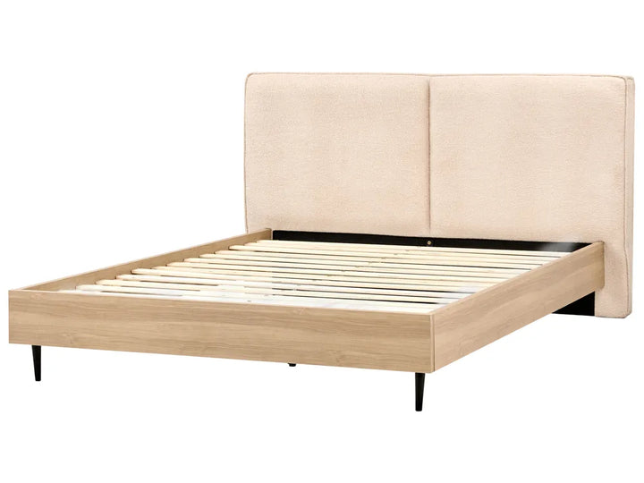 Beige upholstered bed frame with wooden slats on a white background