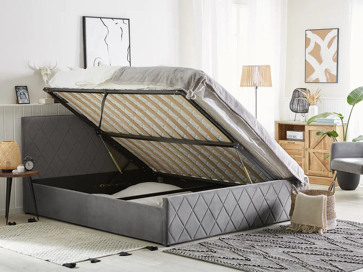 Gray upholstered bed with storage compartment in a bedroom setting