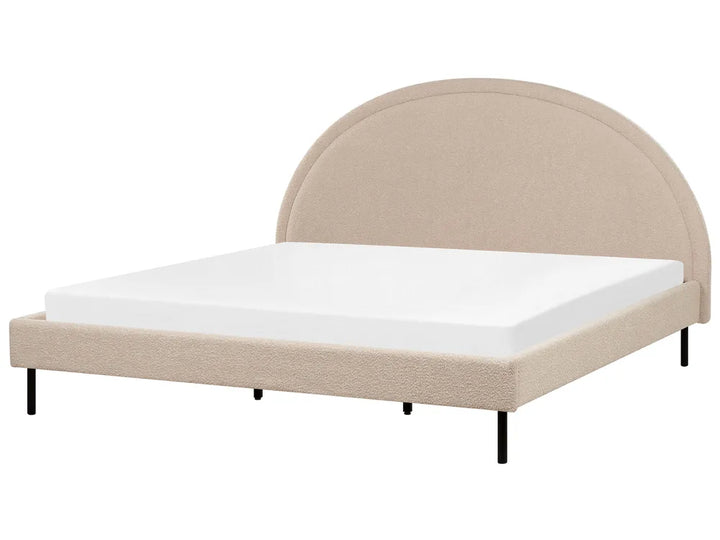 Beige upholstered bed with white mattress on a white background
