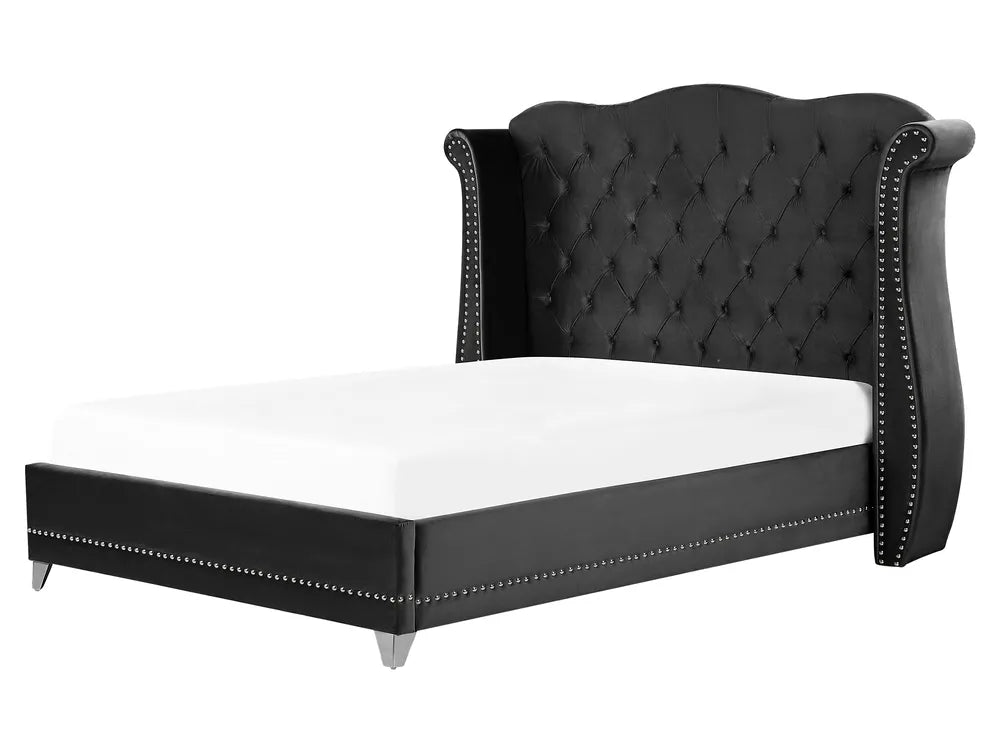 Black tufted bed frame with white mattress on a white background
