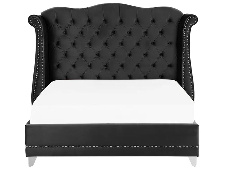 Black tufted bed with white mattress on a white background