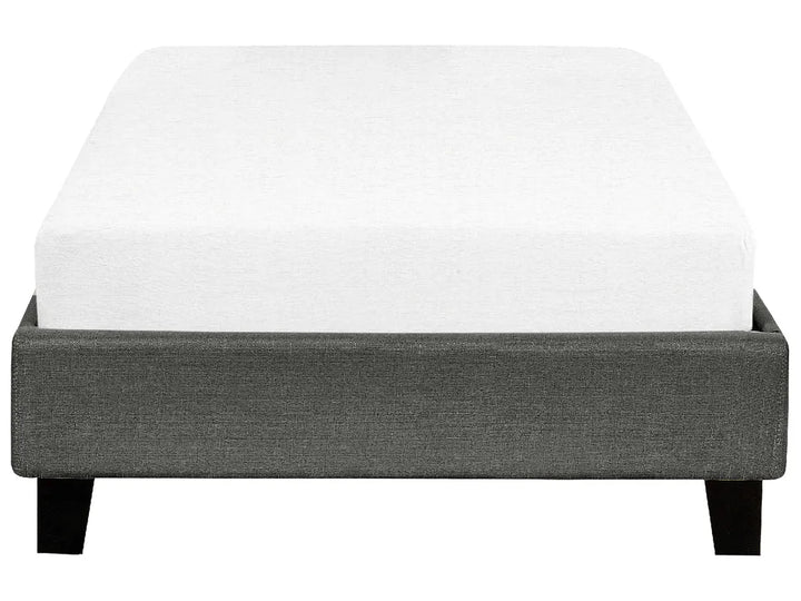 Gray upholstered bed frame with a white mattress on a white background