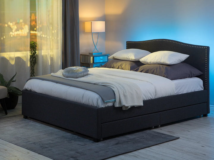 Upholstered bed with camelback headboard and nailhead trim