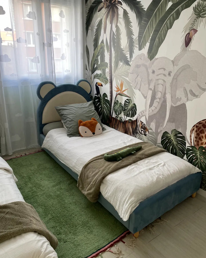 Children's bedroom with a bed and animal-themed wallpaper