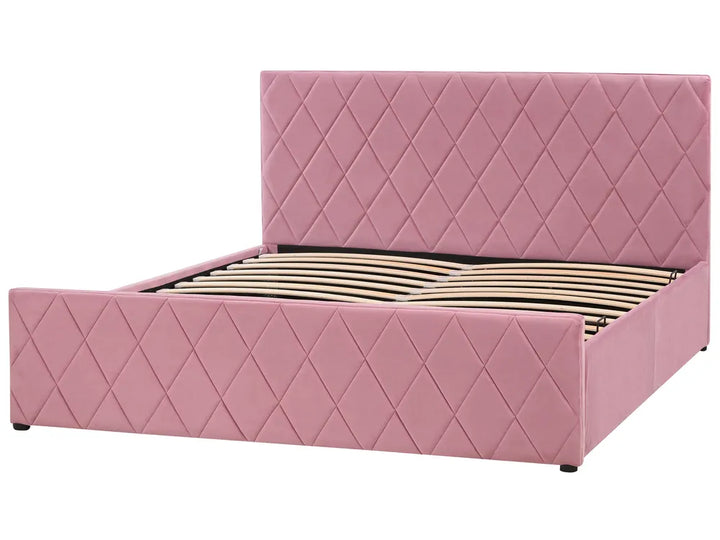 Pink quilted bed with diamond pattern on a white background
