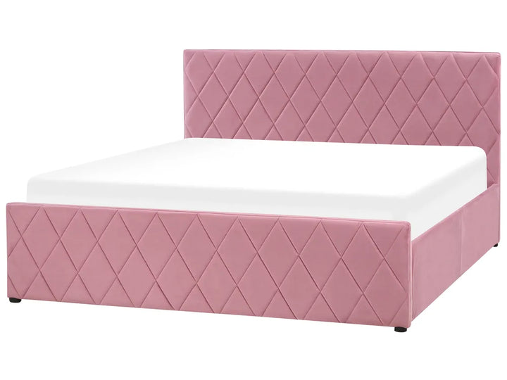 Pink quilted bed with white mattress on a white background