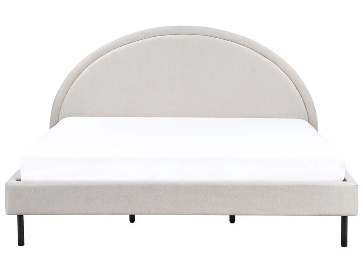 Beige upholstered bed frame with white mattress on a white background