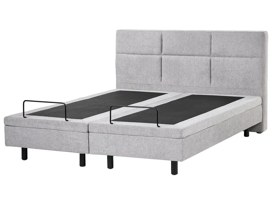 Gray upholstered bed with adjustable base on a white background