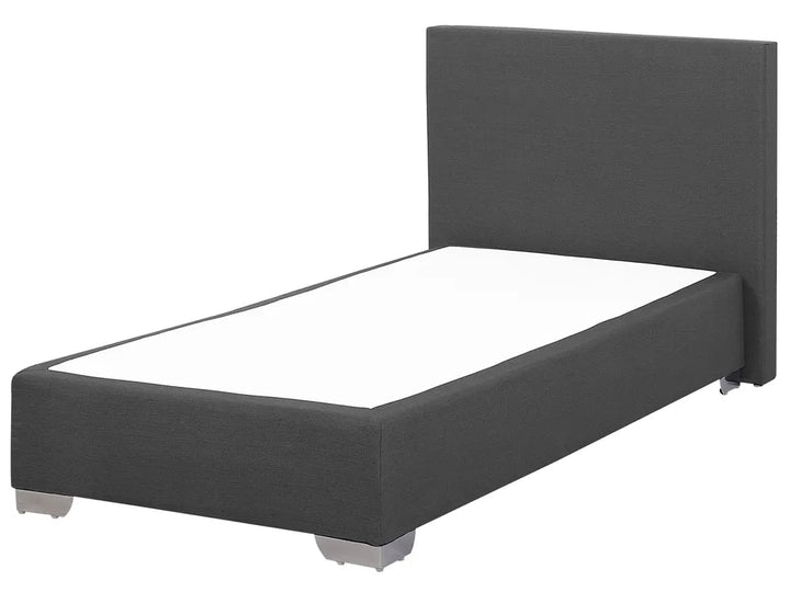 Dark gray upholstered bed with white mattress on a white background