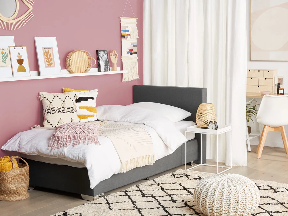 Modern bedroom with a bed, nightstands, and decorative items.