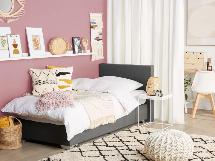 Modern bedroom with a bed, nightstands, and decorative items.