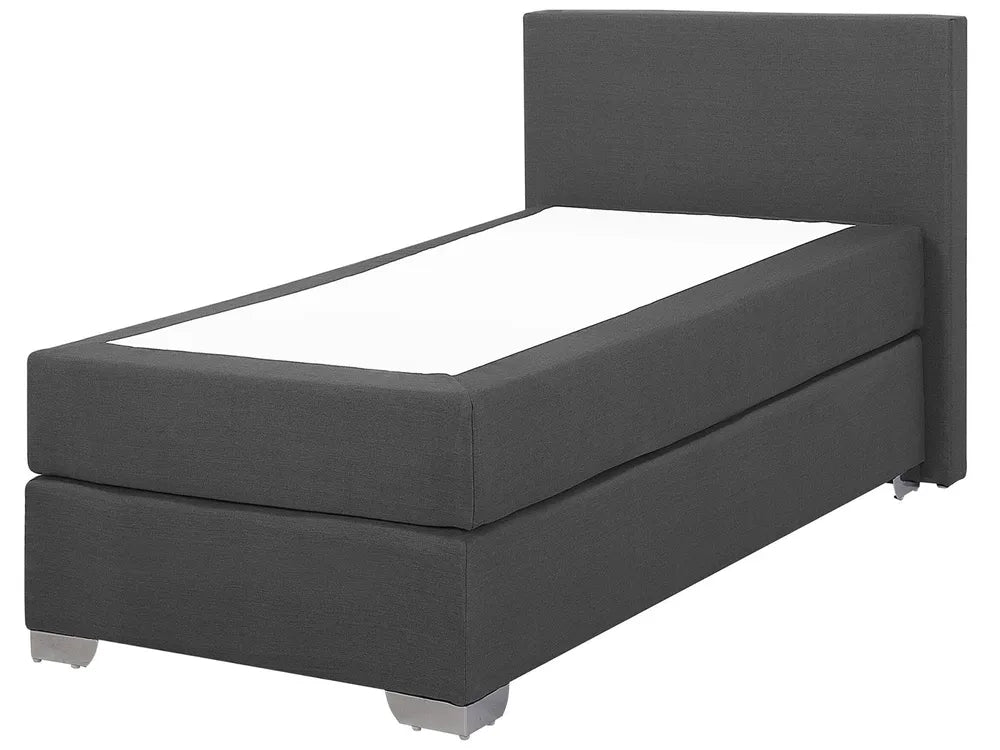 Dark gray upholstered bed with white mattress on a white background