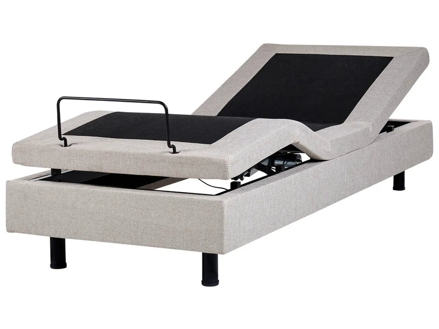Gray adjustable bed with black control panel on a white background