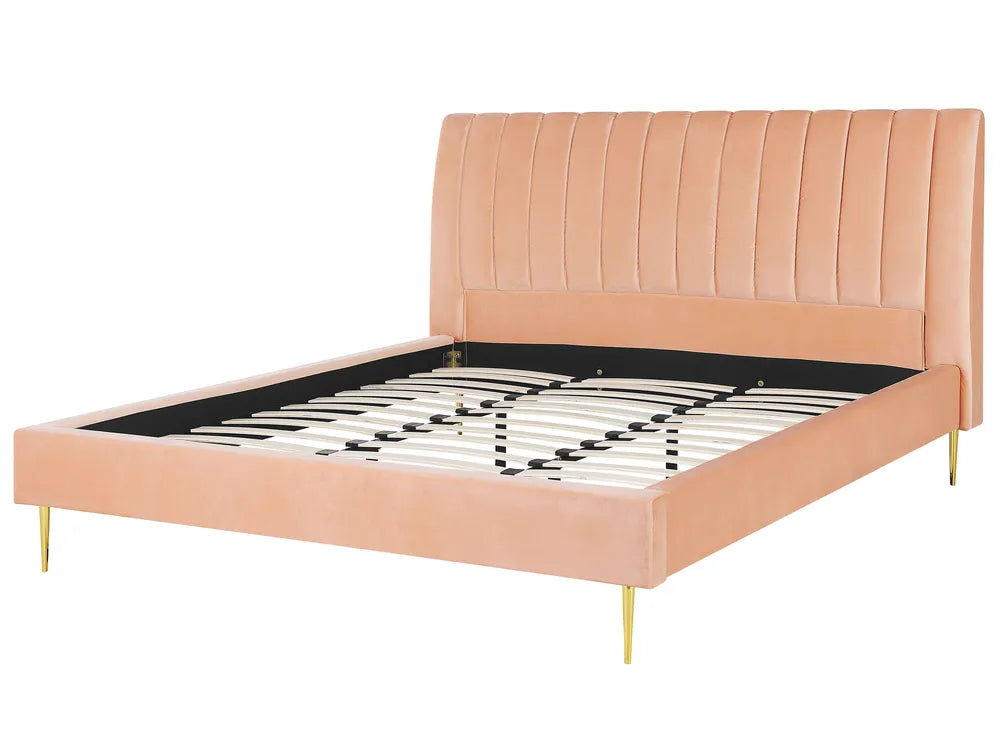 Pink upholstered bed frame with a white background