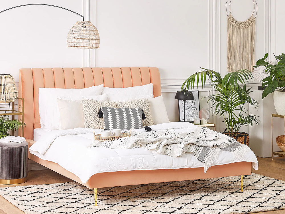 Neatly made bed with decorative pillows in a bedroom setting.