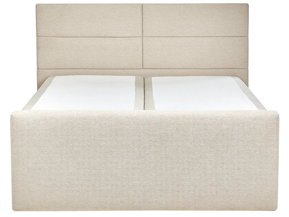 Beige upholstered bed with white mattress and pillows on a white background