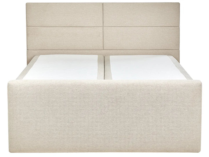 Beige upholstered bed with white mattress and pillows on a white background