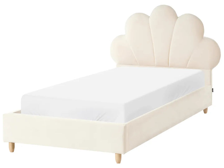 Beige bed with scalloped headboard on a white background